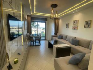 a living room with a couch and a table at Al amirat martil luxury only family in Martil
