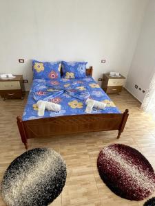 a bedroom with a bed with two spheres on it at Vila Du Lac Blue in Pogradec +5 photos