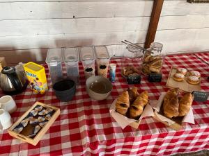 a table with pastries on a red and white table cloth at Rifugio Delle Grotte in Castellana Grotte