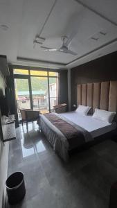 a bedroom with a large bed and a desk at HOG - House of Gypsy in Rishīkesh