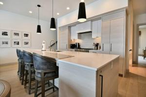 a kitchen with a large island with bar stools at JL802 Juniper Landing Jewel in Park City