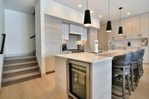 a kitchen with a counter and a bar with chairs at JL802 Juniper Landing Jewel in Park City