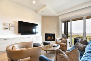 a living room with a couch and a fireplace at JL802 Juniper Landing Jewel in Park City
