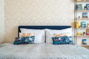 a bedroom with a bed with two pillows on it at Apartment Amélie in Karlovy Vary