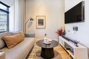 a living room with a couch and a table at Luxury Mountain View Aparthotel at The Tokyo- 12th Floor No Loadshedding in Cape Town