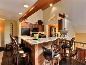 a kitchen with a large counter with chairs around it at RP128 Ski-IN OUT Silver Lake in Park City