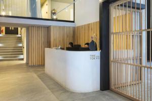 a lobby with two people sitting at a counter at Luxury Mountain View Aparthotel at The Tokyo- 12th Floor No Loadshedding in Cape Town +42 photos