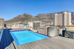 a swimming pool on the roof of a building at Luxury Mountain View Aparthotel at The Tokyo- 12th Floor No Loadshedding in Cape Town