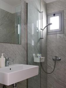 a bathroom with a sink and a shower at Vironas Hotel in Himare