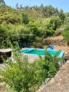 a swimming pool in the middle of a hill at Guest Room B&B Agro-turismo Quinta da Fonte in Figueiró dos Vinhos
