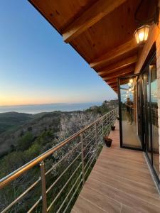 a balcony with a view of the ocean from a house at Restorant Hotel Xheni in Durrës