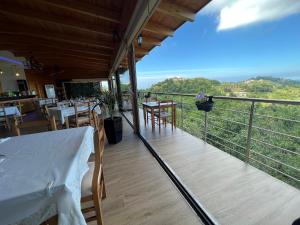 a balcony of a restaurant with a table and chairs at Restorant Hotel Xheni in Durrës