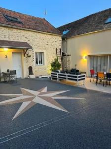 une terrasse avec une grande étoile peinte au sol dans l'établissement Suzy home, à Moisenay