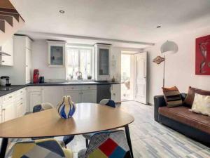 a kitchen and living room with a table and a couch at Suzy home in Moisenay