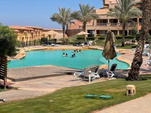 a swimming pool at a resort with people in it at Villa Telal Ain Sokhna in Ain Sokhna