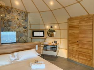 um quarto com uma cama grande e uma janela em GLAMPING DO MAR em Baiona