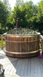 a large wooden tub sitting on a wooden deck at Stor Familjegård i bra läge in Finström