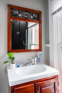 a bathroom with a sink and a mirror at Suite near downtown Louisville, KY - Suite VII in Louisville