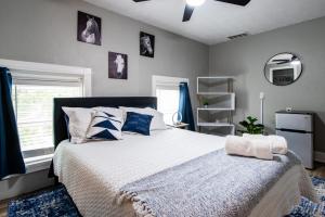 a bedroom with a large bed with blue and white pillows at Suite near downtown Louisville, KY - Suite IX in Louisville
