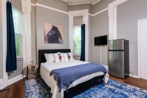 a bedroom with a large bed and a refrigerator at Suite near downtown Louisville, KY - Suite II in Louisville