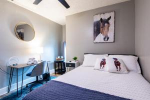 a bedroom with a bed with a picture of a horse at Suite near downtown Louisville, KY - Suite X in Louisville