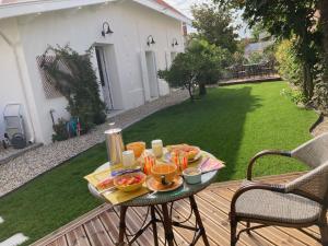 a tray of food on a table on a deck at Chambres d'hotes - B&B Soulac 23 in Soulac-sur-Mer +42 photos