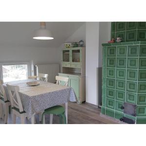 a dining room with a table and a green cabinet at Apartman Nada in Ozalj