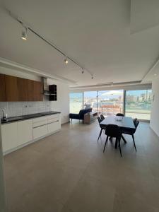 a kitchen and dining room with a table and chairs at Ta Xbiex Sea Front Penthouse in Taʼ Xbiex