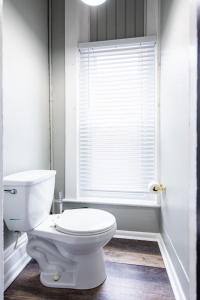 a bathroom with a white toilet and a window at Suite near downtown Louisville, KY - Suite VIII in Louisville