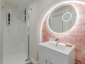 a bathroom with a white sink and a mirror at Walpole House sleeps 19-24 in Margate +42 photos