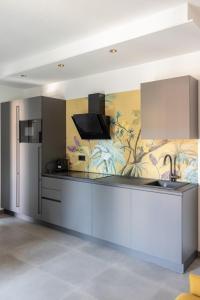 a kitchen with a sink and a refrigerator at ApartmentsGarda - Residenza Garda Deluxe in Garda