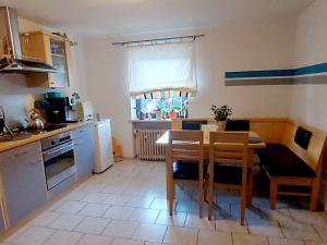 a kitchen with a table and chairs and a dining room at Über den Dächern von Furth im Wald in Furth im Wald +7 photos