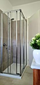 a shower with a glass door in a bathroom at Casa Chicchina in Senigallia