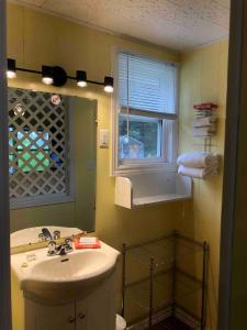 a bathroom with a sink and a mirror at Lakelawn B&B and Motel in Yarmouth