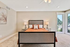 a bedroom with a large bed with two lamps at Stunning Golf Course Retreat 4BR Home in Eagle