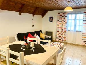 a dining room with a table and a couch at ApartamentsLouis in El Bolsón +8 photos
