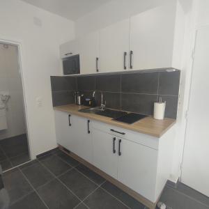 a kitchen with a sink and a counter top at Horváth Apartman in Fertőd