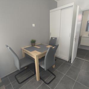 a table and two chairs in a room at Horváth Apartman in Fertőd