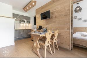 cocina con mesa y sillas en una habitación en La Norma en Terrasse, en Villarodin-Bourget