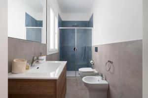 a bathroom with a sink and a toilet and a shower at DipintodiBlu Charming House in Lampedusa