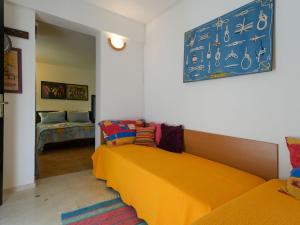 a room with two beds and a blue sign on the wall at Family Villa Rošin with Garden&Pool in Milna
