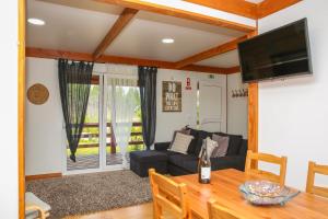 a living room with a couch and a table at Quinta do Sol in Lourinhã