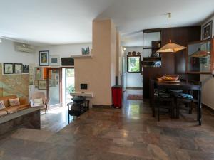 a living room with a table and a dining room at Villa Rošin with Garden&Pool in Milna