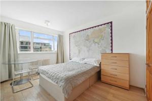 a bedroom with a bed and a map on the wall at 3Bed Apartment Pimlico London in London