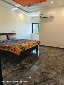 a bedroom with a bed in a room at POP Hotel Harsh in Aurangabad