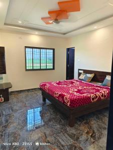 a bedroom with a bed and a ceiling fan at POP Hotel Harsh in Aurangabad