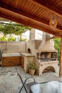 an outdoor kitchen with a stove and a table and chairs at Marios house 