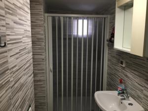a bathroom with a sink and a shower at Casa Movida in Trapani