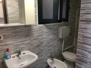 a bathroom with a sink and a toilet at Casa Movida in Trapani