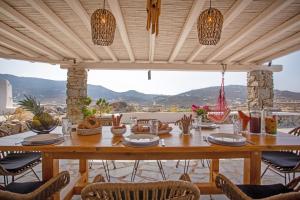 a table on a patio with a view of the mountains at Villa Surfland in Elia